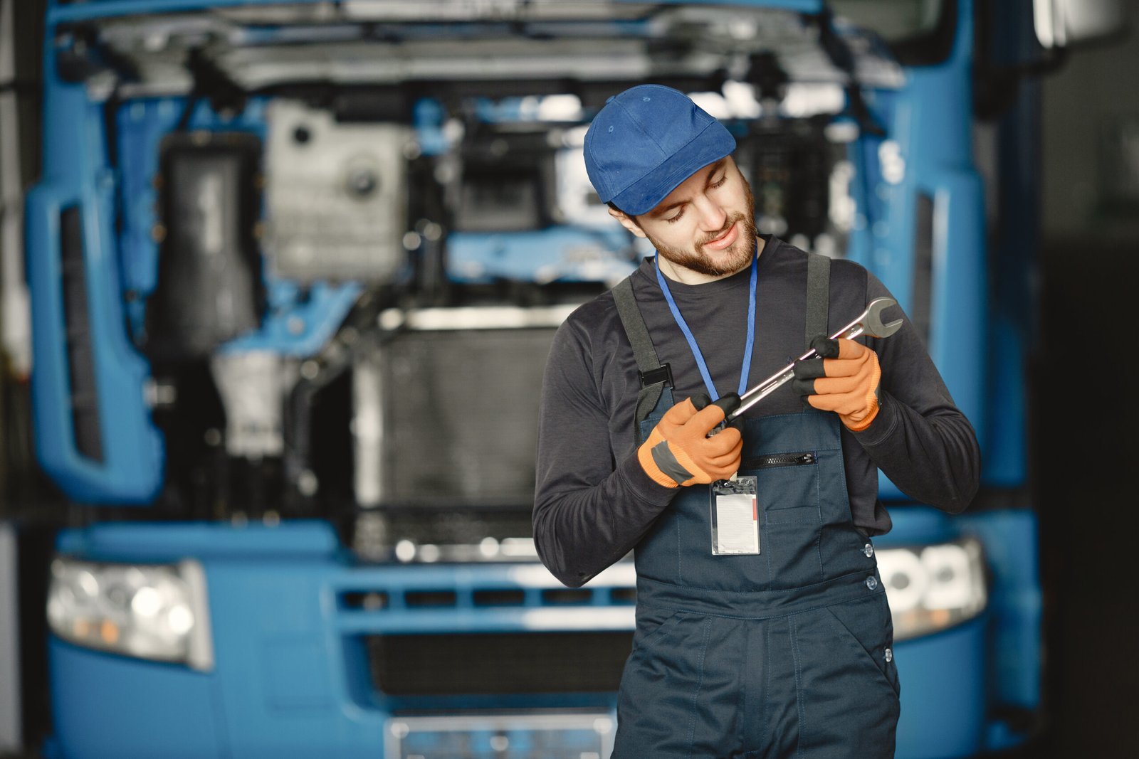 worker uniform man repairs truck man with tools scaled